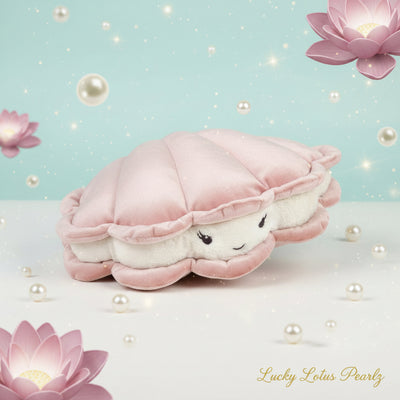 Pink oyster plush with a smiling pearl face displayed on a soft aqua background with floating pearls, realistic lotus flowers, and gold Lucky Lotus Pearlz script.