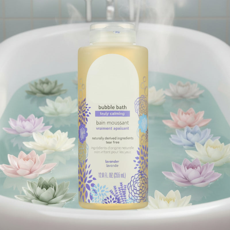 Lavender bubble bath bottle placed in front of a tub filled with water and floating pastel lotus flowers, creating a soothing, spa‑like relaxation scene.