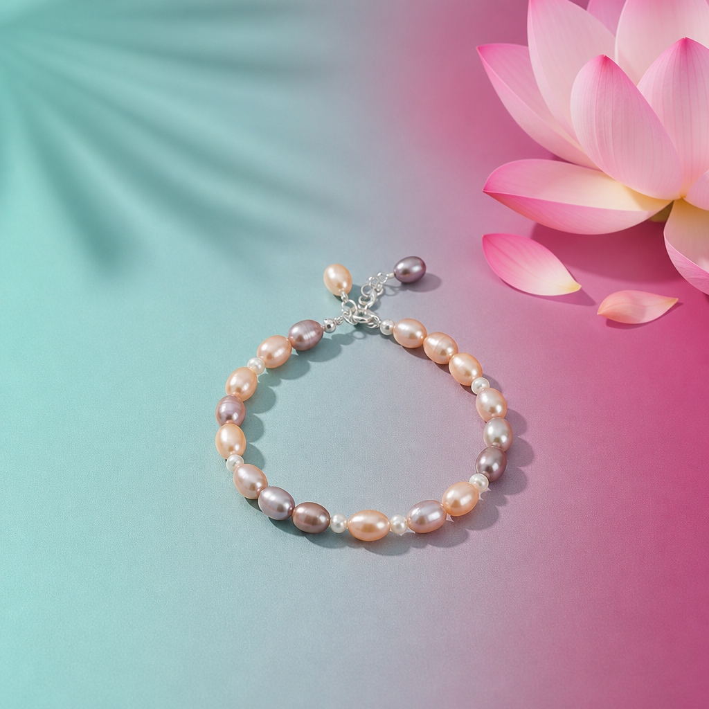 Mixed‑color freshwater pearl bracelet with lavender, peach, and white pearls arranged in a circle on a soft aqua‑mint and lotus‑magenta background with a lotus flower accent.
