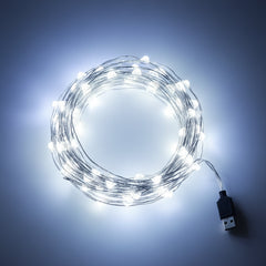 White LED fairy lights glowing brightly on flexible wire.